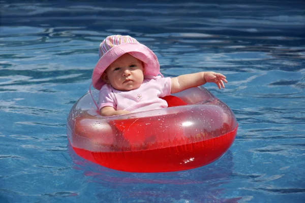 Baby girl in plastic boat