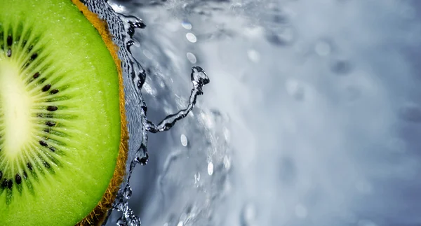 Kiwi fruit over water splashing