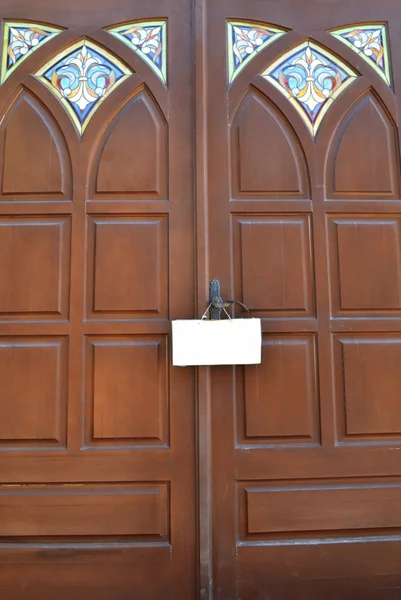 Clean doorplate on the handle of a wooden door