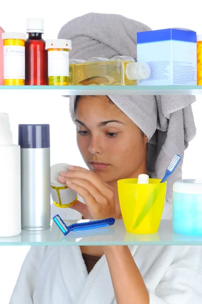 Woman Looking in Medicine Cabinet