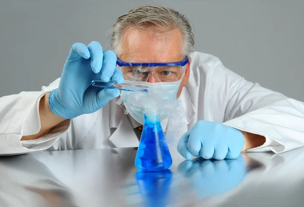 Scientist with test tube and beaker