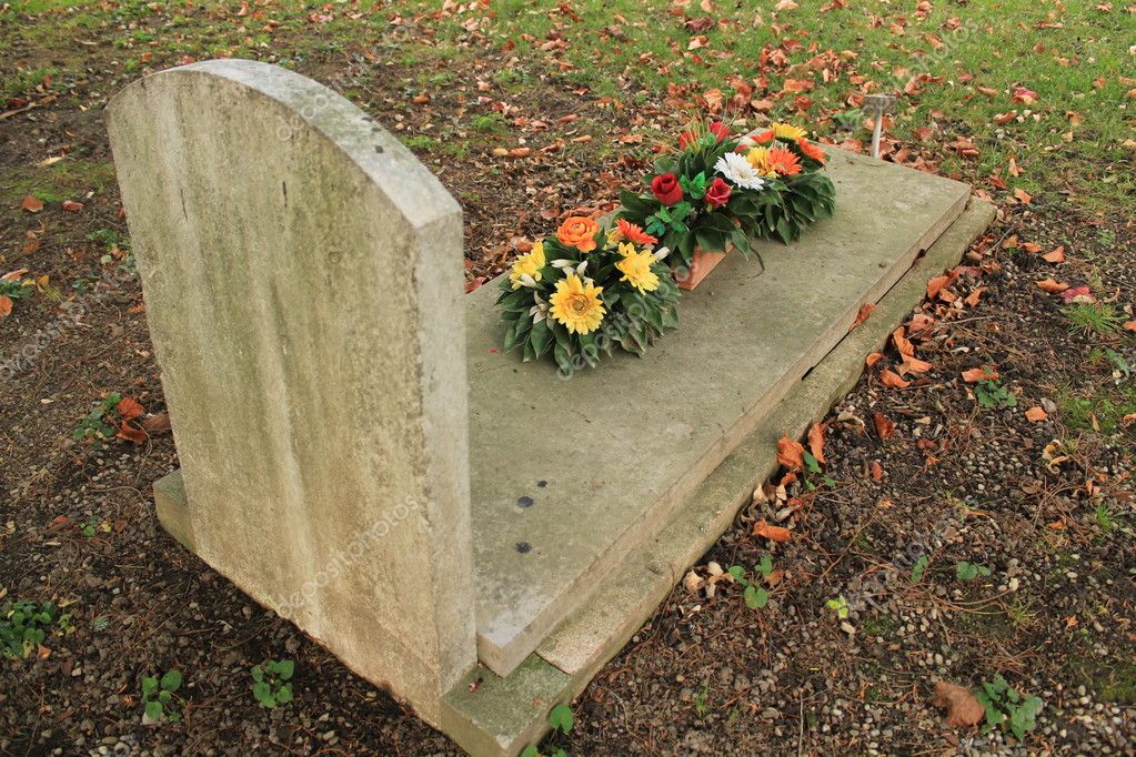 Tombstone with flowers — Stock Photo © Elenarts 5896898