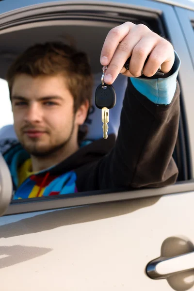 Man holding out car keys