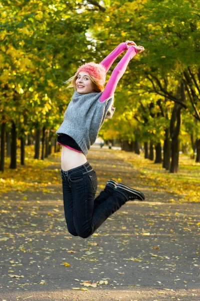 Joyful young woman jumping in the park