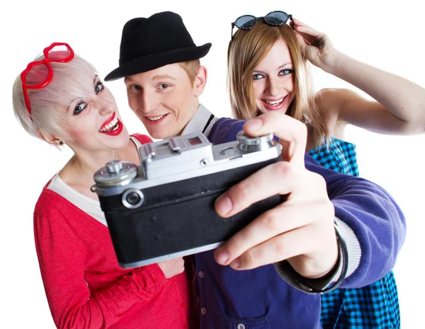 Joyful teenage friends with photo camera