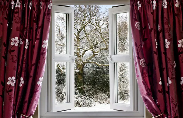 Open window with view to a snowy winter scene