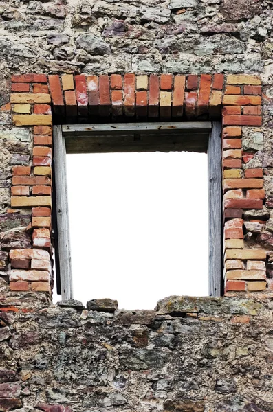 Ruined rustic limestone boulder rubble wall window frame