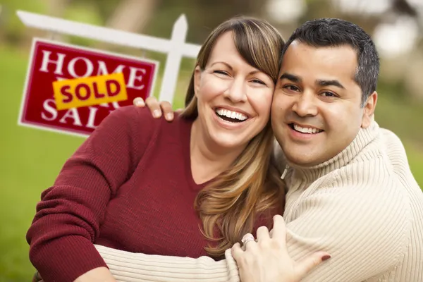 Mixed Race Couple in Front of Sold Real Estate Sign — Stock Photo #5672920