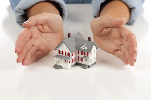 Womans Hands Around Model House