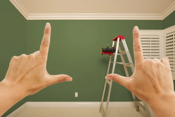 Hands Framing Green Painted Wall Interior