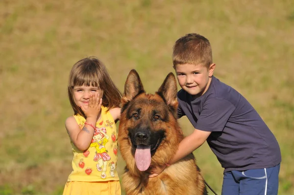 Boy and girl with German shepherd