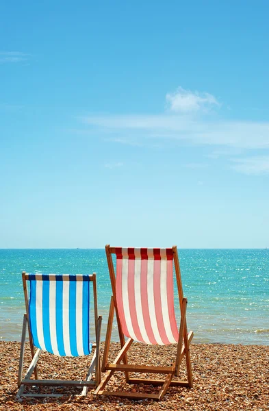 Two deck chairs on the beach