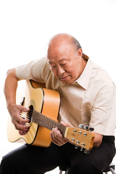Senior asian playing guitar