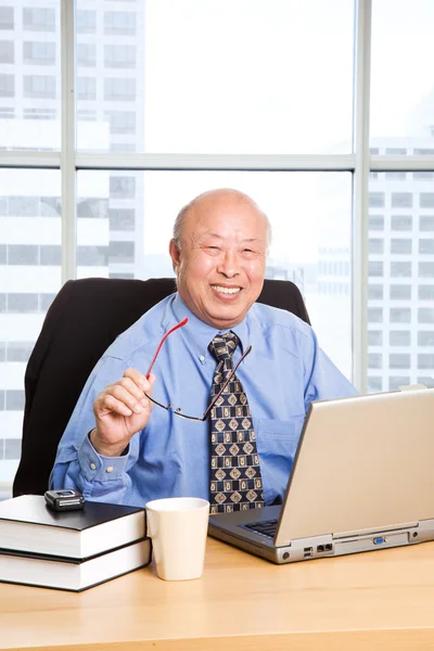 Working senior asian businessman