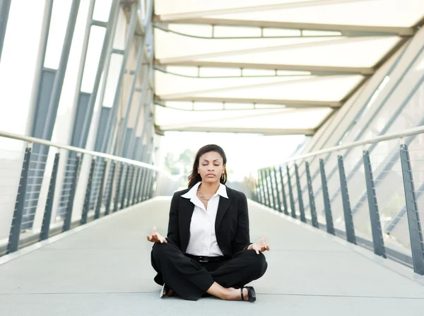 Black businesswoman meditating