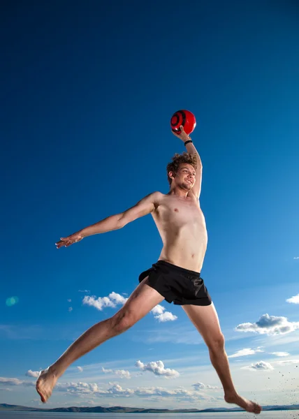 Male beach volleyball game player jump in blue sky — Stock Photo #6088485