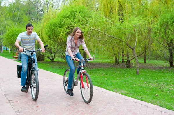 Happy young couple riding bicycles