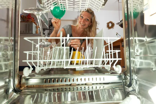 Young woman seen from inside of a dish washer