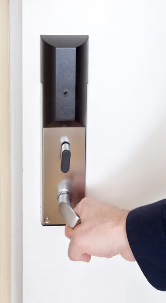 Close-up of hand opening door handle