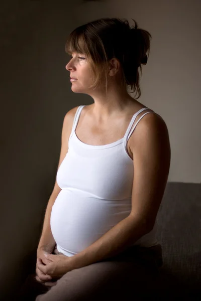 Pregnant woman lost in thought