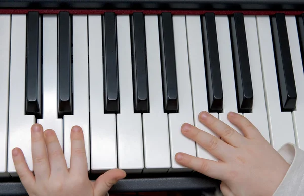 Young boys hands playing piano or keyboard