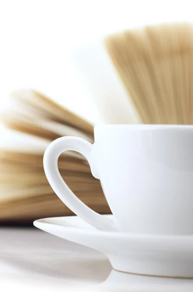 Cup of coffee and book close-up