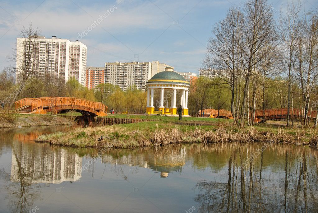 Gazebo on an island in the middle of the pond, reflected in the ...
