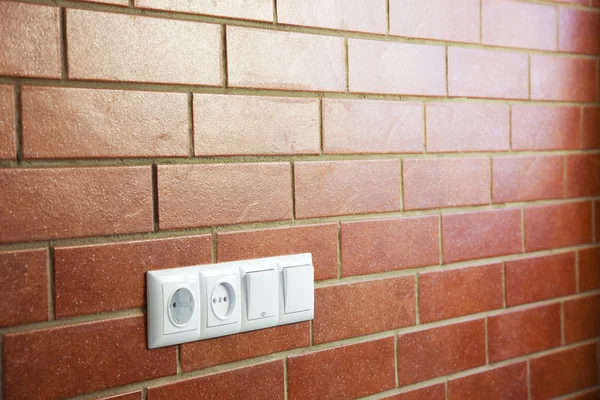 Power outlets on the brick wall / horizontal / photo