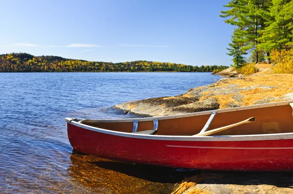 Red canoe on shore