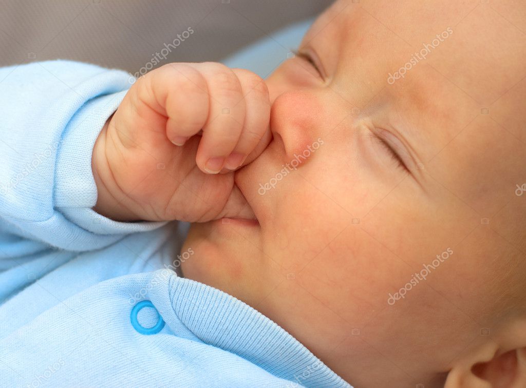 Baby boy sucking thumb to fall