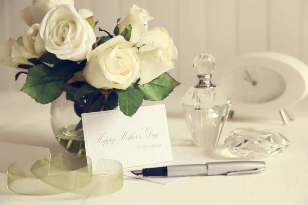Note card with white roses and pen
