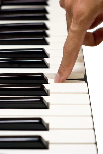Artist finger on piano key