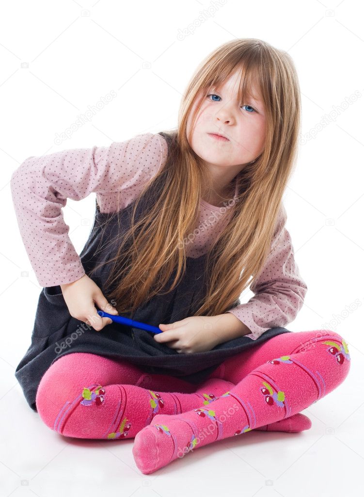 Little girl sit with felt pen with intense face isolated on white