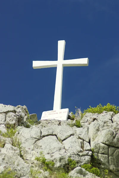 White cross against deep blue sky