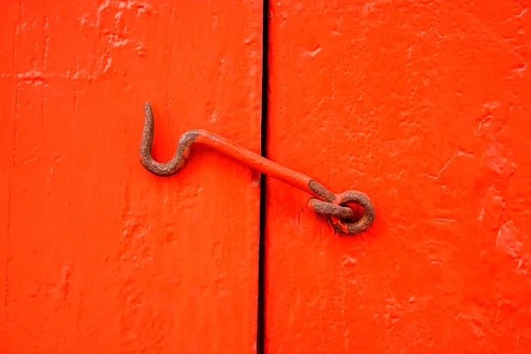 Metal hook on red doors