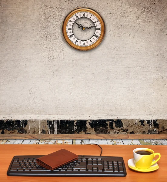 Keyboard on desk and a business clock in old room