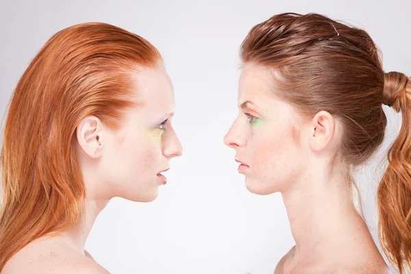 Profile of two red-haired woman