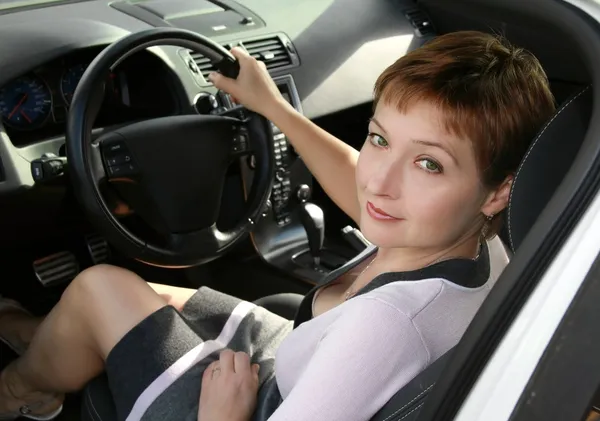 Inside interior of sport auto with driving beautiful woman