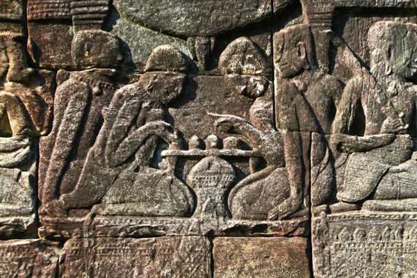 Ancient carving in Bayon temple showing playing in chess, Angkor wat