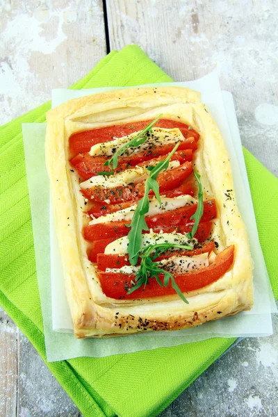 Tart of puff pastry with peppers and goat cheese vegetable appetizer