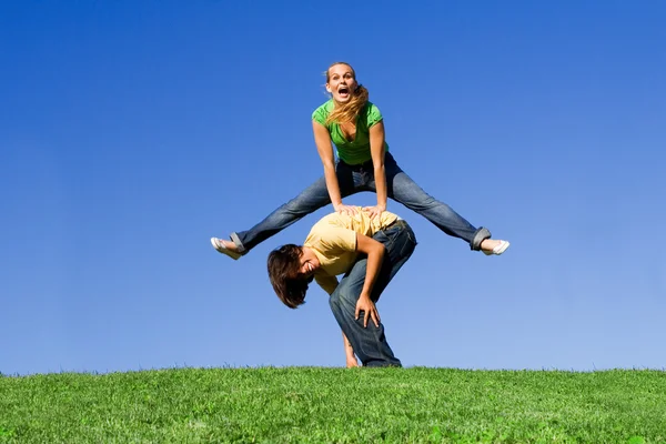 Active teens playing leapfrog