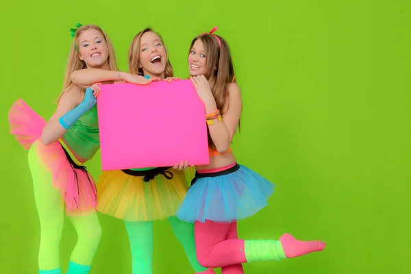 Fashion girls in neon clothing holding blank pink billboard