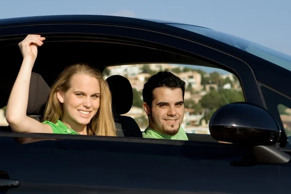 Couple on road trip in new or hire rental car