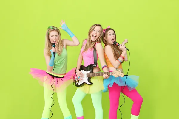 Girl band, group of girls singing and playing guitar