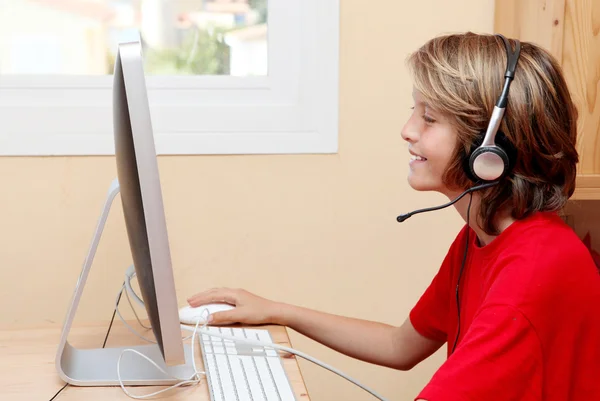 Child with headphones or earphones listening to music or chatting on home p