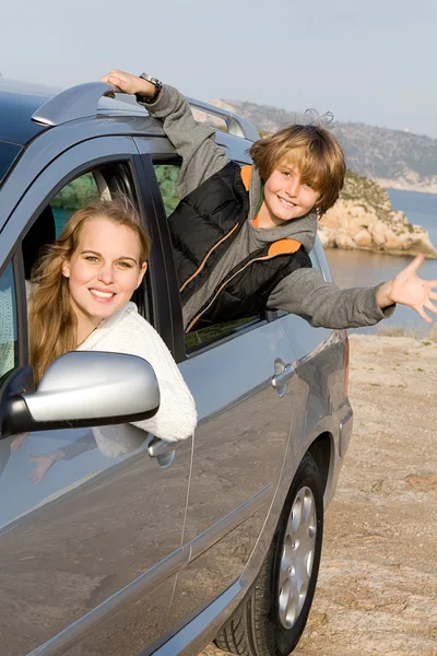 Mother and son in new hire or rented car on vacation