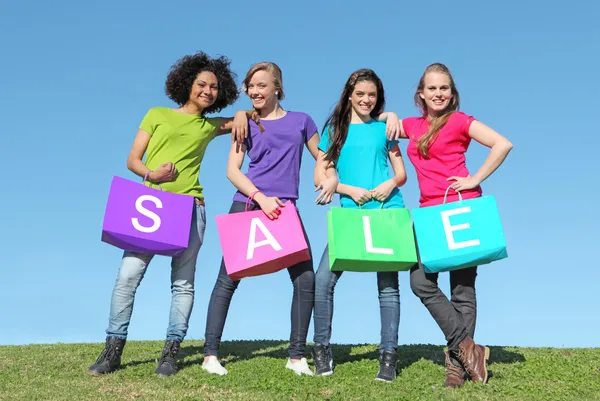 Group of girls shopping in sales with bags