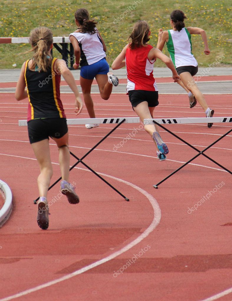 Girls running 200 meter hurdles — Stock Photo © DenysKuvaiev 6118718