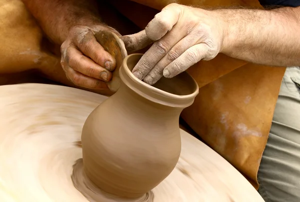Potter making clay jug