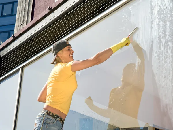 Women cleaning a window